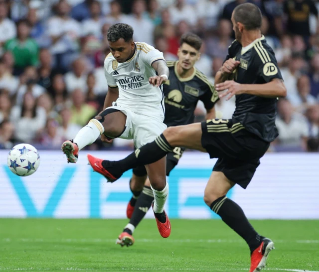 Rodrygo shoots towards goal as a Union Berlin defender attempts to block it