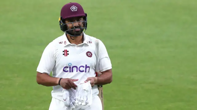 Karun Nair returns to the changing room after rain stops play