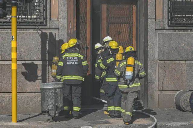 Firefighters entering building