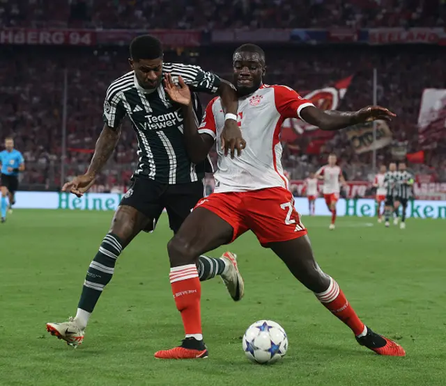 Marcus Rashford of Manchester United in action with Dayot Upamecano