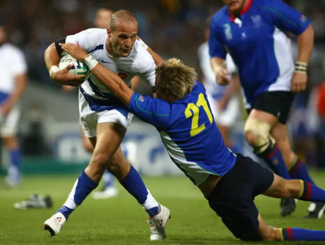 Frederic Michalak of France is tackled by Lu-Wayne Botes of Namibia