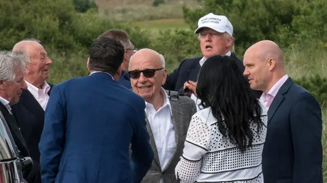 Murdoch (C) visiting then-Republican presidential candidate Donald Trump while on a trip to Scotland in June 2016