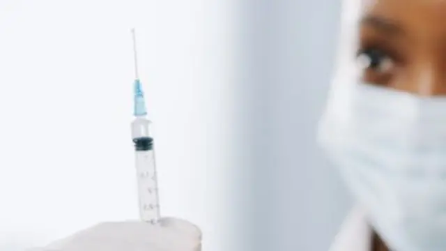 Generic shot of a doctor holding a vaccine