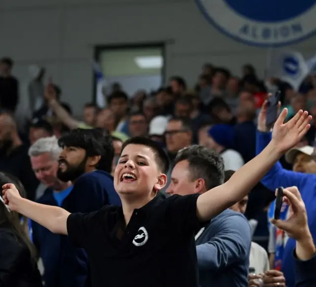 Brighton fans wave flags and sing songs as their European qualification is confirmed.