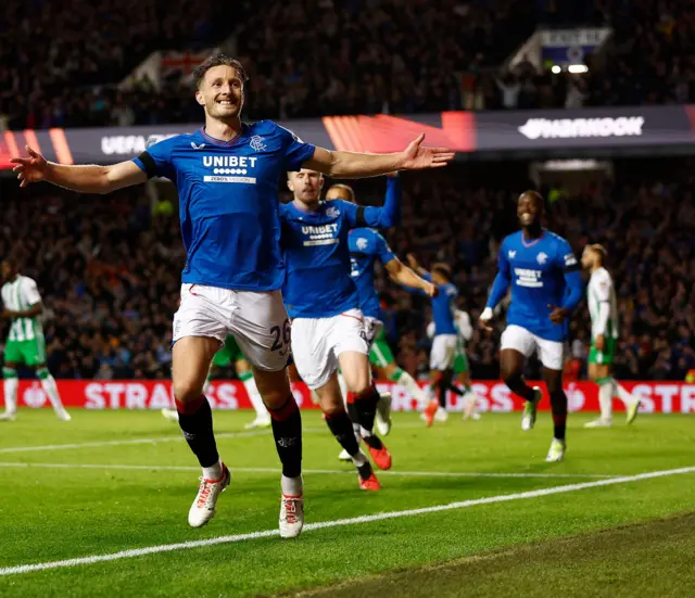 Davies celebrates with teammates in pursuit as Rangers take the lead.