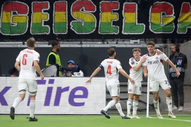 Polvara is joined by teammates at the corner flag to celebrate their equaliser.