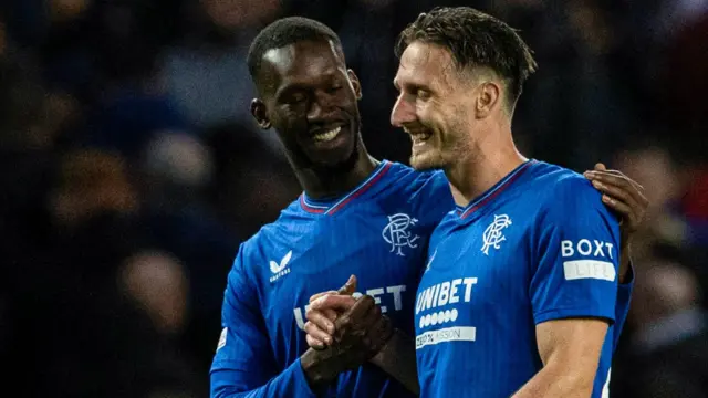 Abdallah Sima and Ben Davies celebrate