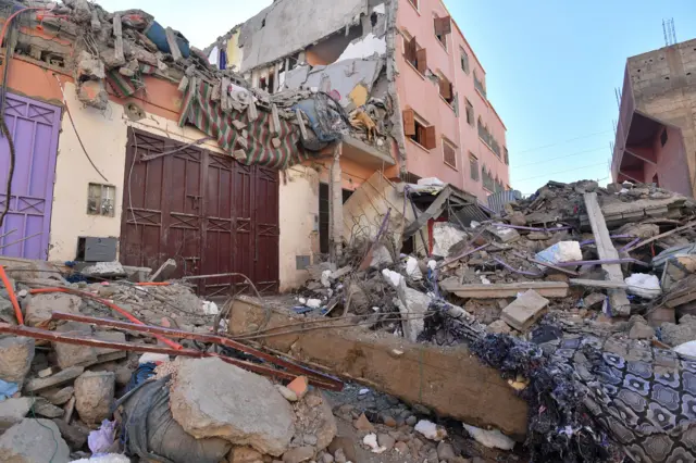 Building rubble blocks a street in Mzouda village in Morocco's Chichaoua province following a devastating earthquake, on September 10, 2023.