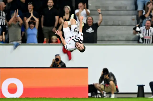 Flecker does a backflip in mid air to celebrate his goal.