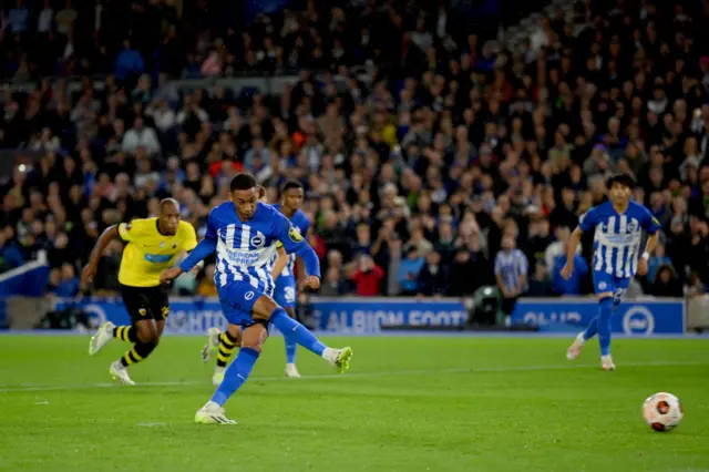 Joao Pedro strokes home from the penalty spot to equalise for Brighton.