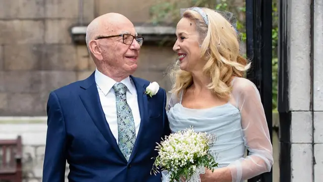 Rupert Murdoch and his new bride, former US model Jerry Hall pose for a photograph outside St Bride's church on Fleet Street in central London on 5 March 2016, after attending a ceremony of celebration of their marriage