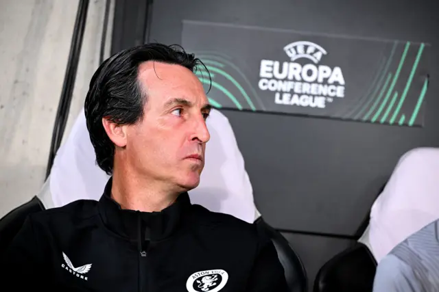 Emery looks on intensely while sat on the bench.