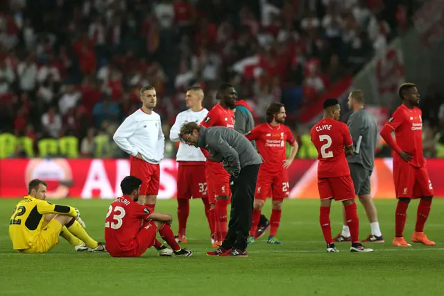 Jurgen Klopp consoles his players on the pitch after defeat to Sevilla in the Europa League final in 2016.