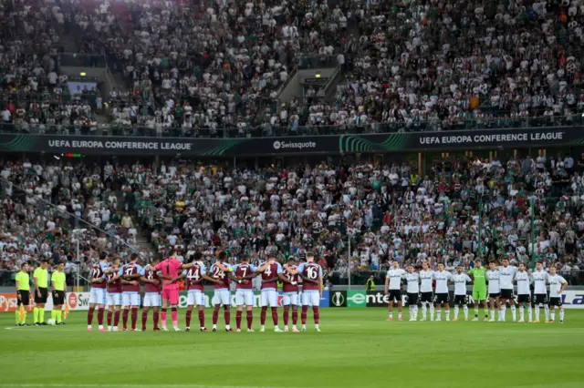 Players observe a moments silence before kick off.