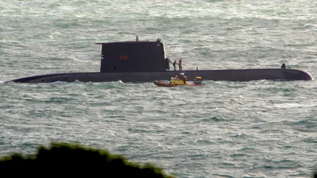 A rescue boat is seen next to a South African Navy submarine, after an incident during exercises off Kommetjie in Cape Town, South Africa September 20, 2023