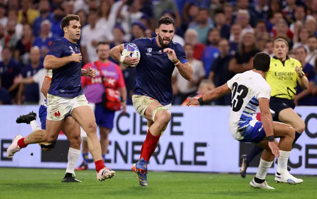 Charles Ollivon of France makes a break toscore the team's twelfth try