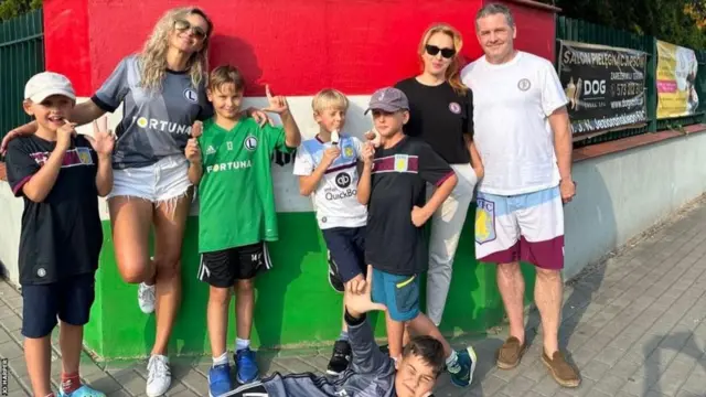 West Ham fan Jo Harper stands with his Legia supporting neighbour.