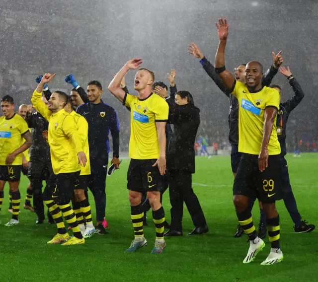 AEK players dance and celebrate with the travelling fans after their momentus win.