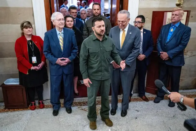 President Zelensky speaks to the media with Chuck Schumer and Mitch McConell behind him