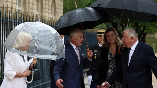 Britain's King Charles, speaks with President of the French National Assembly Yael Braun-Pivet and France's Senate President Gerard Larcher, as he leaves with his wife Queen Camilla, after addressing Senators and members of the National Assembly at the French Senate, the first time a member of the British Royal Family has spoken from the Senate Chamber, in Paris, France September 21, 2023.