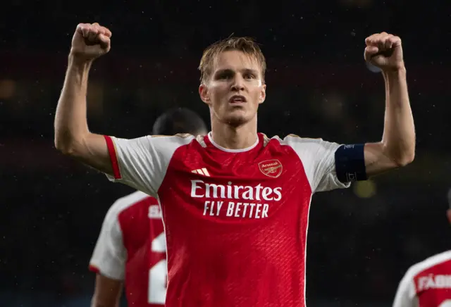 Martin Odegaard holds up both arms