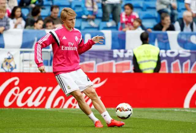 Martin Odegaard kicks a ball while at Real Madrid