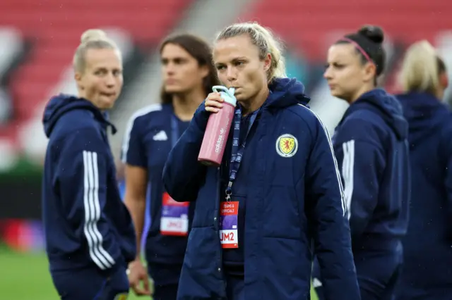 Claire Emslie drinks from her water bottle while surveying the pitch.