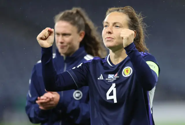 Rachel Corsie throws her fists in the air to acknowledge the fans at full time.