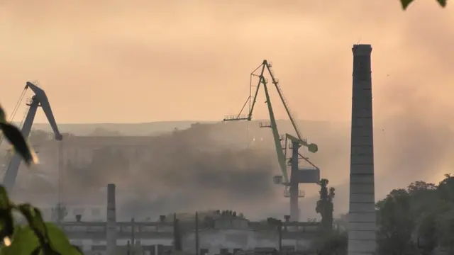 Smoke rises from an industrial area