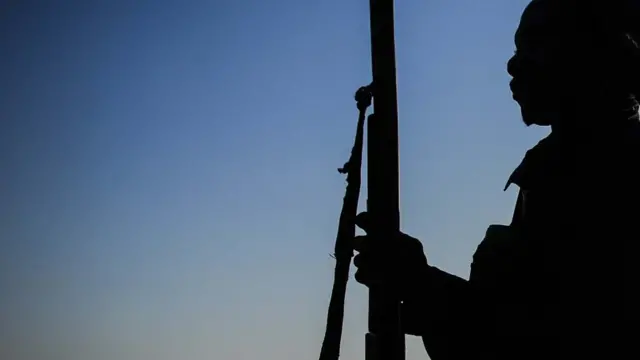 Man holding gun, silhouette