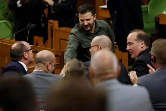 Zelensky shaking hands with Canadian politicians