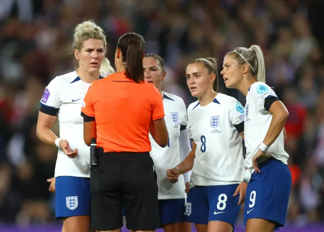 England players questioning referee