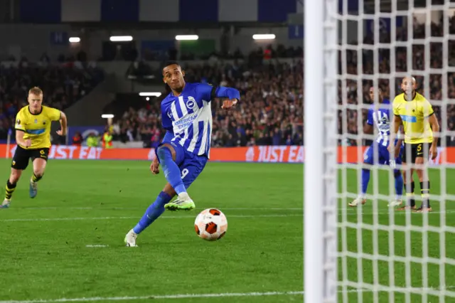 Joao Pedro kicks a ball