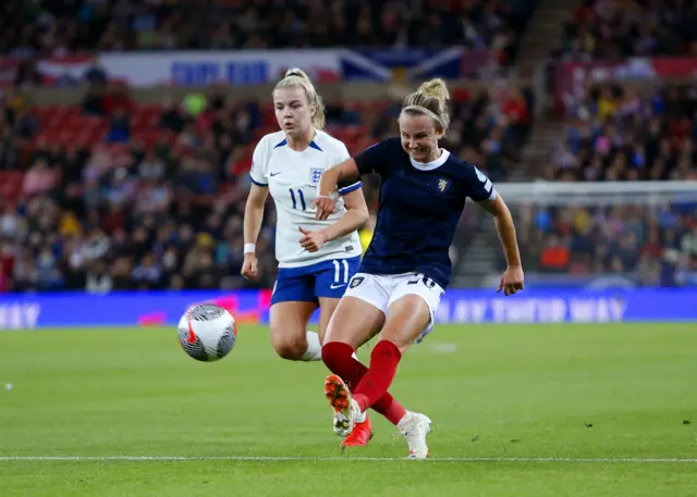 Lauren Hemp and Scotland's Martha Thomas battle for the ball