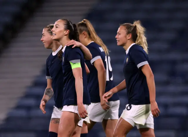 Caroline Weir celebrates with Scotland teammates after their goal.