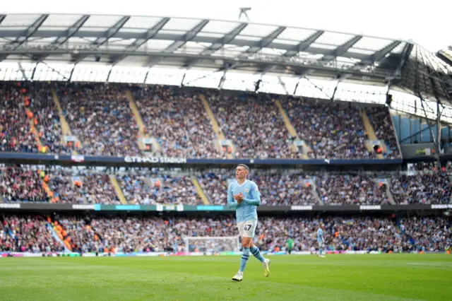 Phil Foden of Manchester City applauds fans