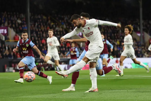 Fernandes takes aim at goal while under pressure from a Burnley defender.