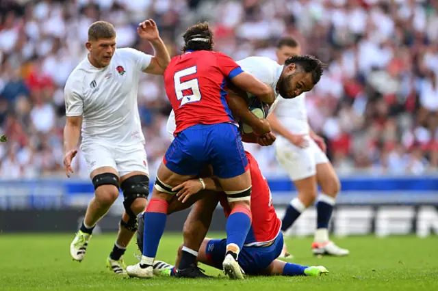 Billy Vunipola of England is challenged by Martin Sigren