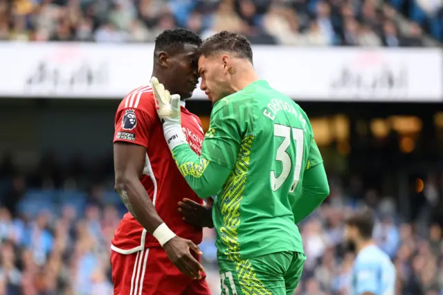 Taiwo Awoniyi of Nottingham Forest clashes with Ederson