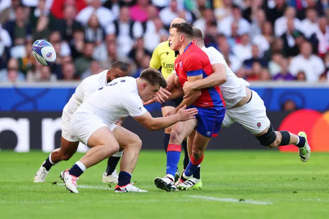 Benjamin Videla of Chile is tackled by Theo Dan and Jack Willis