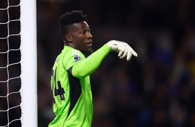 Onana shouts and points orders at his defence from his net.