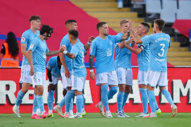 Jorgen Larsen of RC Celta celebrates with his teammtes after scoring the team's first goalduring the LaLiga EA Sports match between FC Barcelona and Celta Vigo at Estadi Olimpic Lluis Companys on September 23, 2023 in Barcelona, Spain.