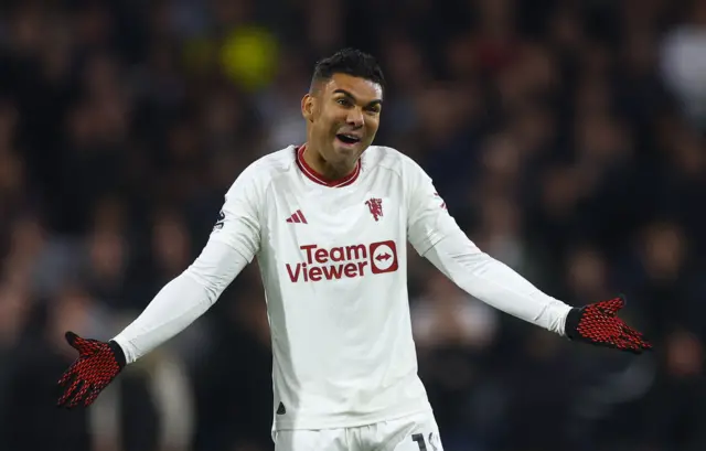 Casemiro laughs while holding his hands out wide.