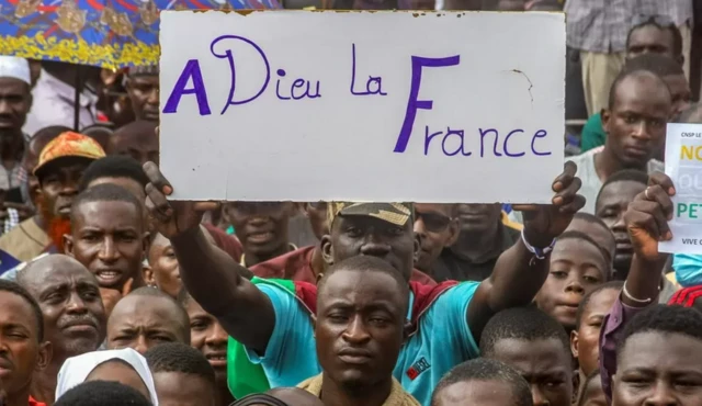 A placard held by supporters that reads "Goodbye France" in french