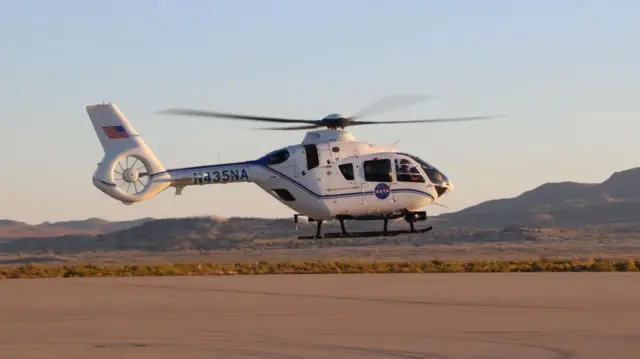 Nasa helicopter taking off with recovery team on board