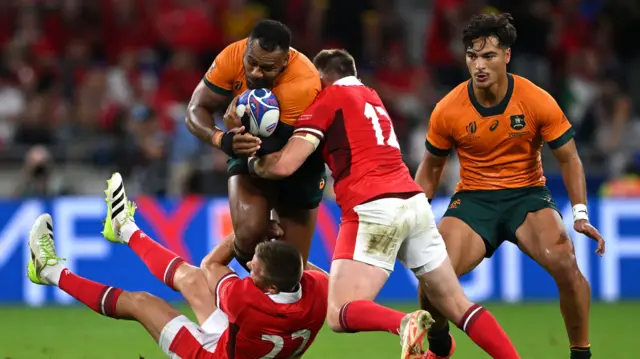 Samu Kerevi of Australia is tackled by Gareth Anscombe and Nick Tompkins of Wales