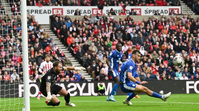 Cardiff's Dimitrios Goutas makes a clearance