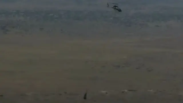 An image of the helicopter carrying the capsule