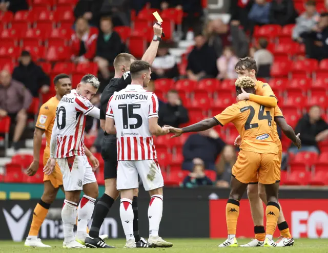 Hull's Jean Michael Seri is shown a yellow card