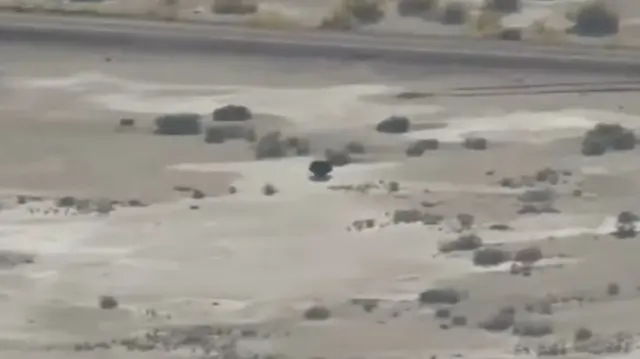 A view of the Utah desert with the capsule in the center